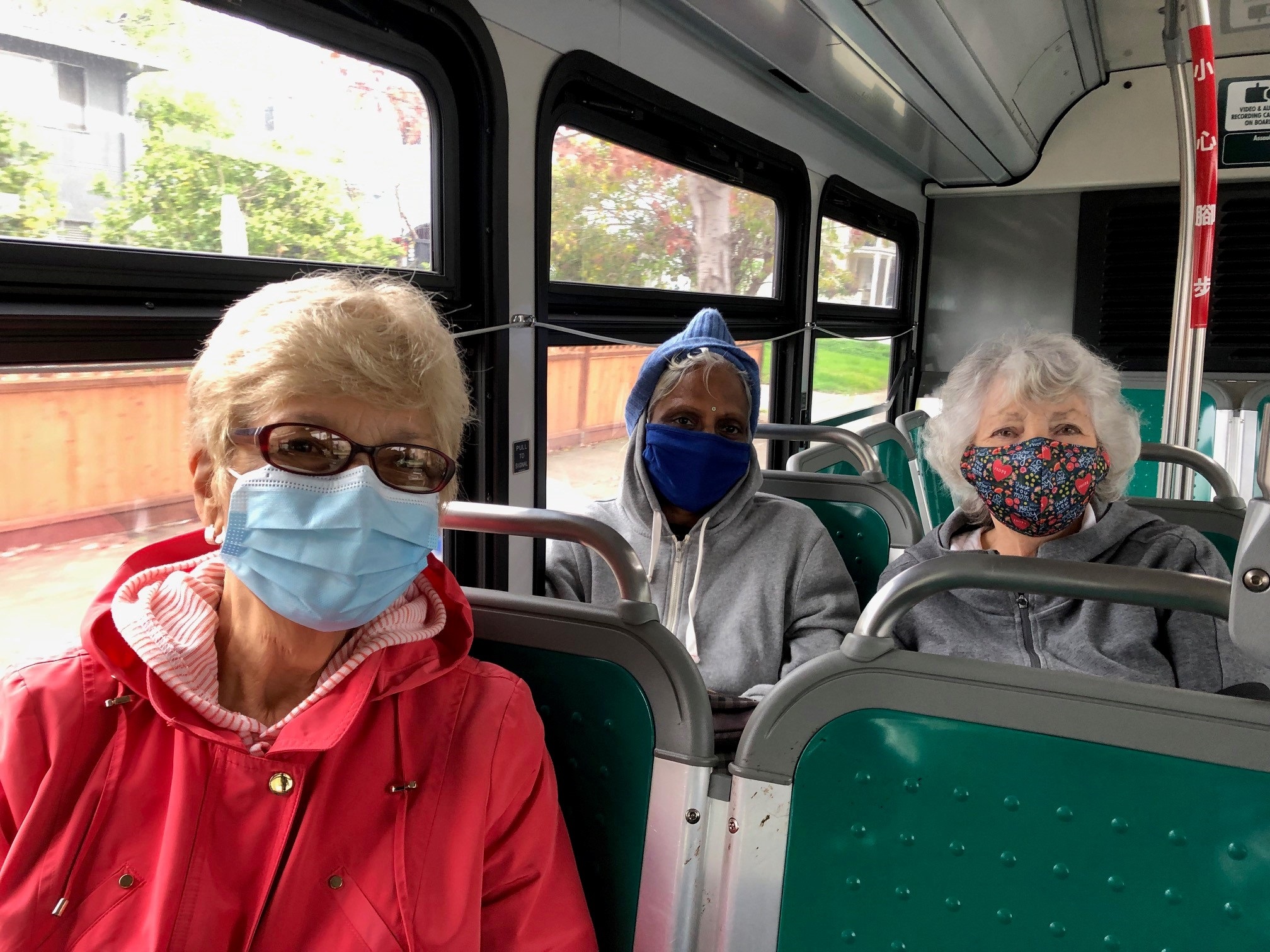 three women riding on a bus.jpg