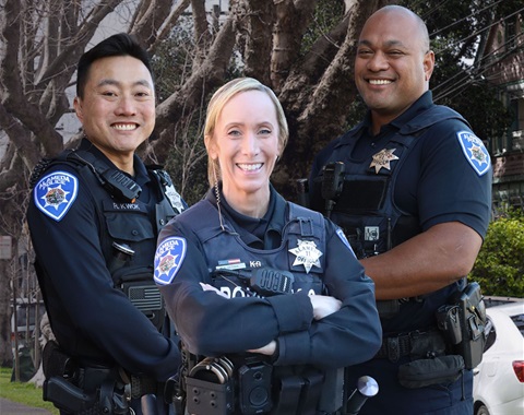 Three officers smiling at the camera
