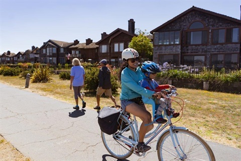 Biking woman with child on Bay Farm