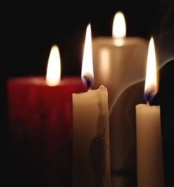 Photo showing four lit candles
