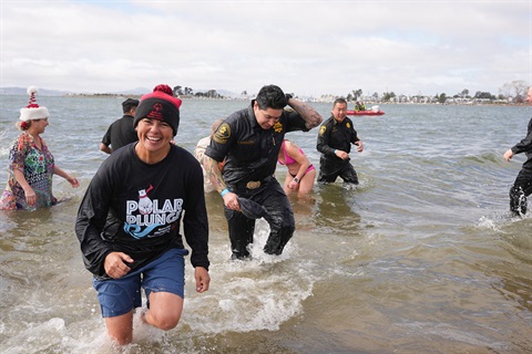 Group of people running out of the water at crown breach 