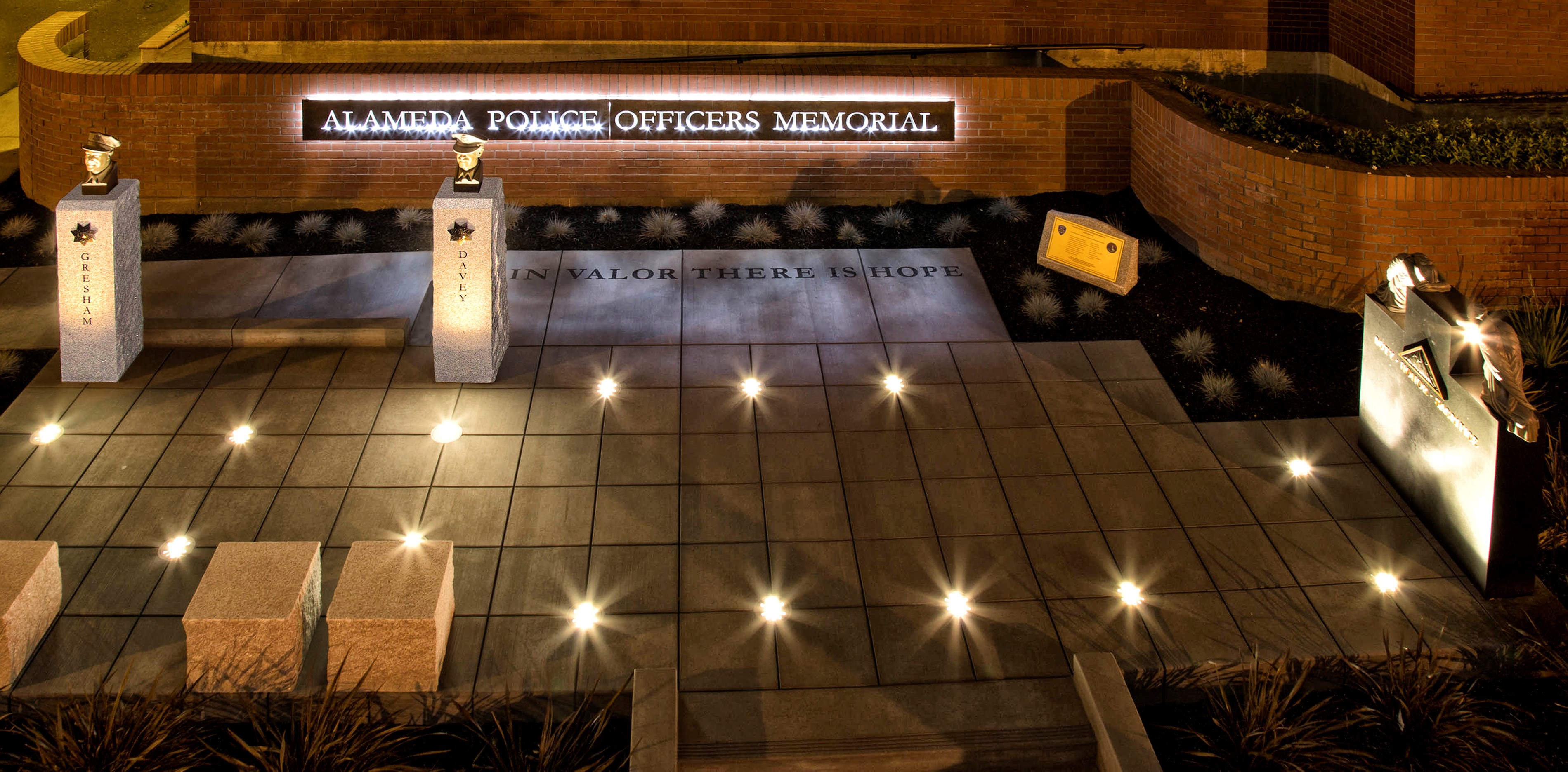 An overview picture of the Alameda Police Memorial at night with the lights on. 