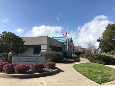 Photo of Fire Station 4 on a sunny day with the flag at half mast